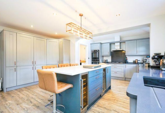 The kitchen is linked by internal bi-folding doors. It is a modern fitted kitchen with central island with breakfast bar and two wine fridges.