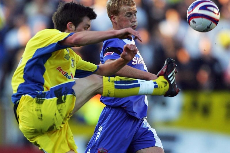 Jonny Howson challenges for the ball with Carlisle United's Chris Lumsdon.