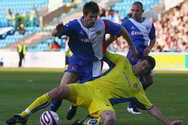 Lubomir Michalik tackles Carlisle United's Scott Dobie.