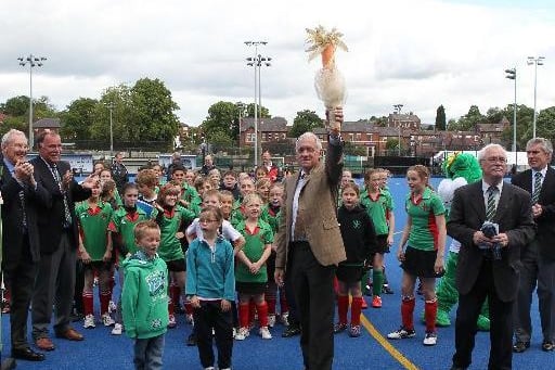 Wakefield Hockey Club opening ceremony. Harry Gration lifts the "Olympic torch" which the junior club members had relayed across both pitches.