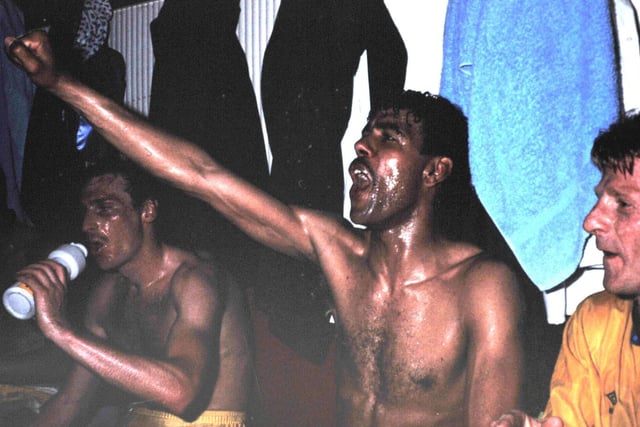 Chris Kamara leads the singing in the dressing room after Leeds United clinched promotion as Division 2 champions.
