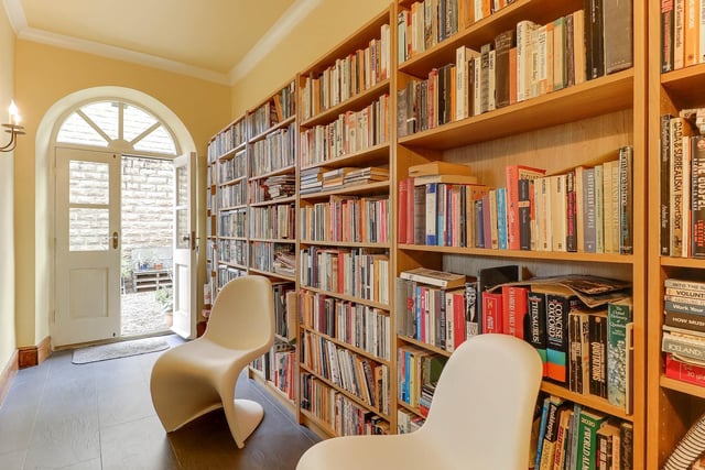 A space lined with shelving and well stocked with books.