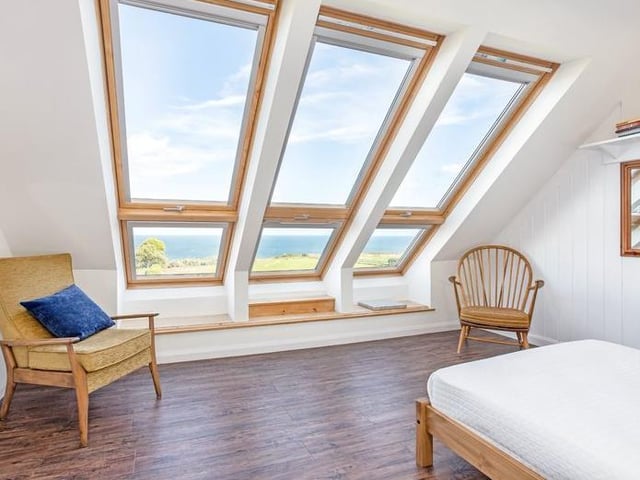 This bedroom of character looks out over the sea.