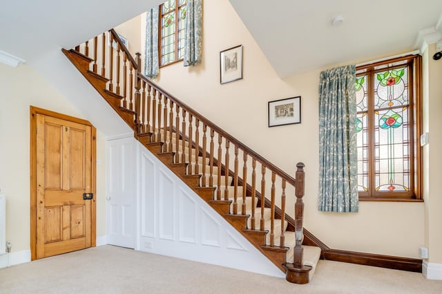 The hall and stairs with two beautiful stained glass windows stealing the show