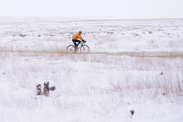 A cyclist braves the weather on Marsden Moor, Yorkshire