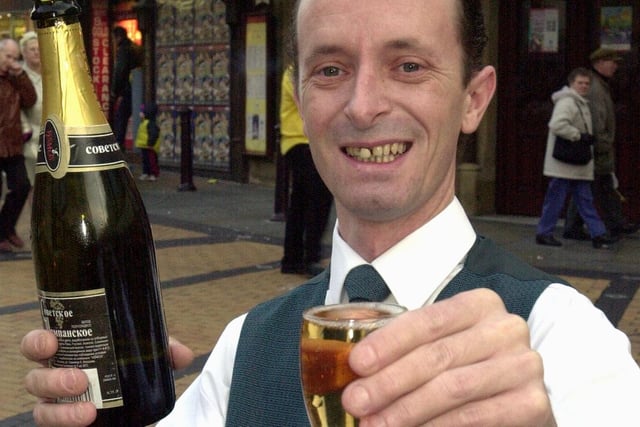 Grand Theatre bars manager James Tyrrell breaks open the champagne, ready for the New Years Eve Gala, 2000
