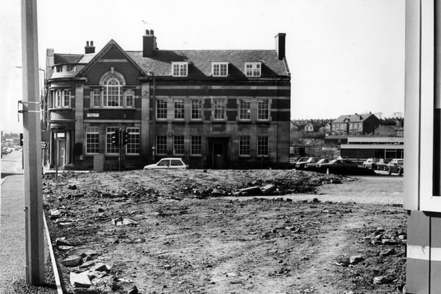 April 1982 and pictured is the old Police Station and Library at the junction between Dewsbury Road and Hunslet Hall Road, from across a stretch of barren land.