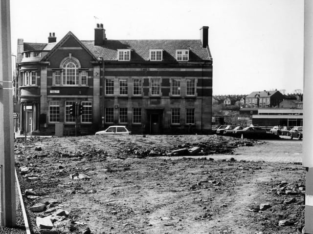April 1982 and pictured is the old Police Station and Library at the junction between Dewsbury Road and Hunslet Hall Road, from across a stretch of barren land.