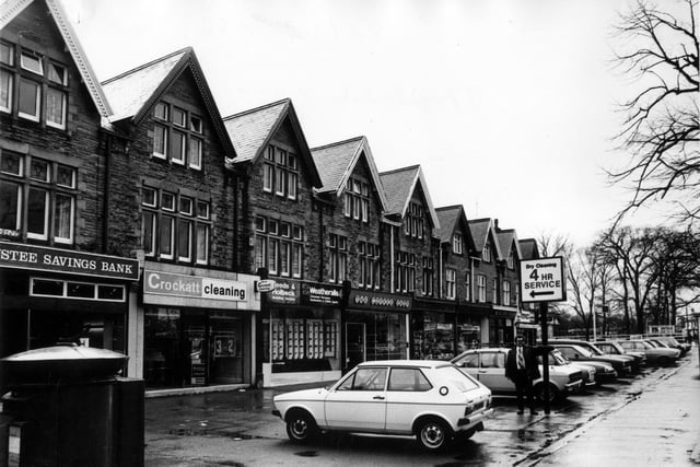 A row of shops and businesses on Street Lane in April 1982. They include Trustee Savings Bank, Crockatt Cleaning, Leeds and Holbeck Building Society and The Coffee Shop.