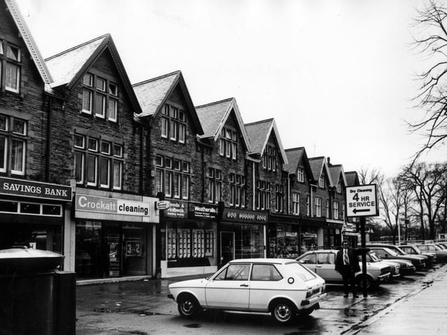 A row of shops and businesses on Street Lane in April 1982. They include Trustee Savings Bank, Crockatt Cleaning, Leeds and Holbeck Building Society and The Coffee Shop.
