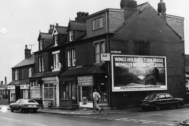 A row of shops on Harehills Lane in March 1982. These include Tyme Style Jewellers, Anglia Building Society and Paul, hair stylist. The junction with Nowell View is on the right.