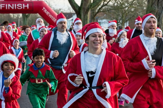Santas and elves setting off from the start line