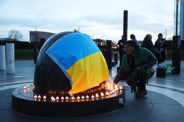 People were invited to light candles which  were placed under the Ukraine flag