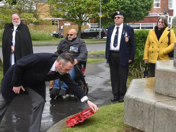 Tony Kelly, committee member of the Royal British Legion in Skegness, lays a wreath at the memorial at St Matthew's Church.