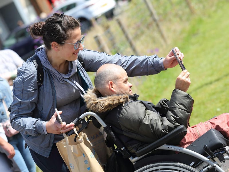 A member of the crowd takes a snap of the action