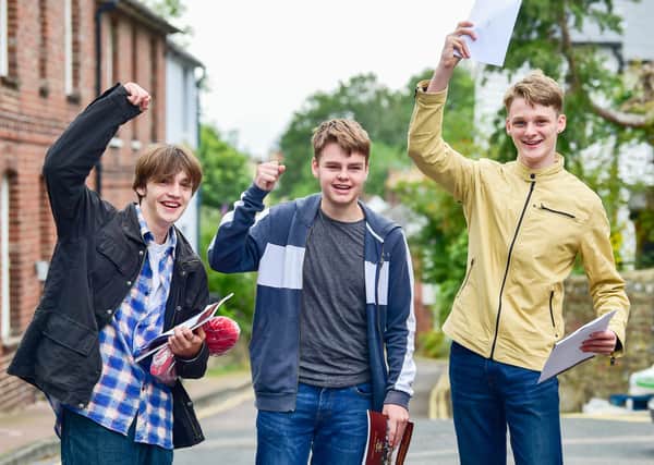 From left, Sterling Furness, Mark Coldbreath and Oliver Goodwin celebrate GCSE results at Lewes Old Grammar School today (August 12). Photograph: Simon Dack/ Vervate