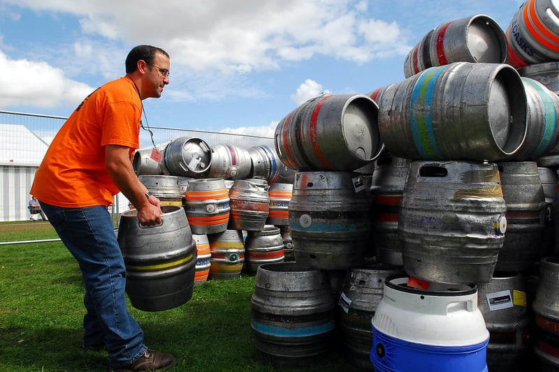 Steve Saldana, a volunteer at the Peterborough Beer Festival, originally from San Anonio, Texas, then residing in Peterborough, adds an empty cask to the pile as the festival draws to a close