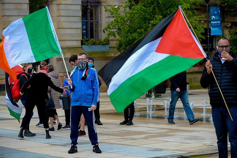 A Palestinian flag waved alongside the Irish tri-colour, in the Guildhall Square, at Saturday afternoon‘s rally in solidarity with the people of Palestine. Photo: George Sweeney.  DER2119GS – 019