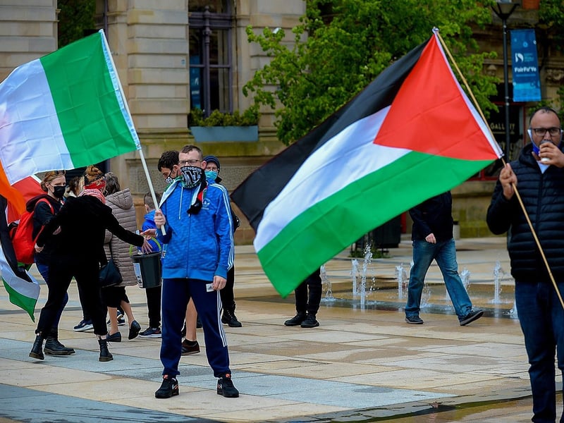 A Palestinian flag waved alongside the Irish tri-colour, in the Guildhall Square, at Saturday afternoon‘s rally in solidarity with the people of Palestine. Photo: George Sweeney. DER2119GS – 019