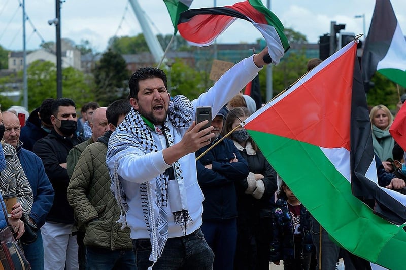 Protester with Israeli flags tied to his shoes during the rally in Guildhall Square, on Saturday afternoon last, calling for an end to the violence against the people of Palestine. Photo: George Sweeney.  DER2119GS – 036