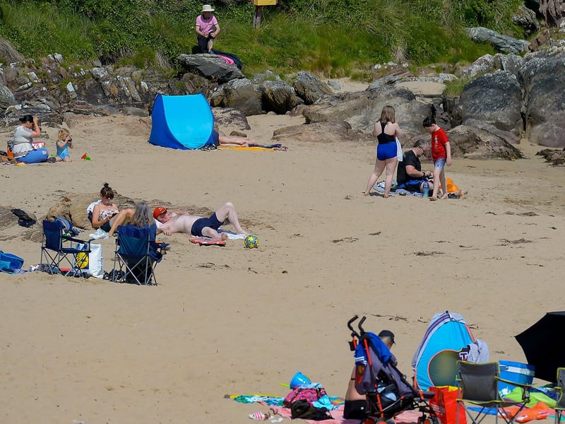 People on the beach at Shroove during the recent mini heat wave in Inishowen. DER2129GS - 071
