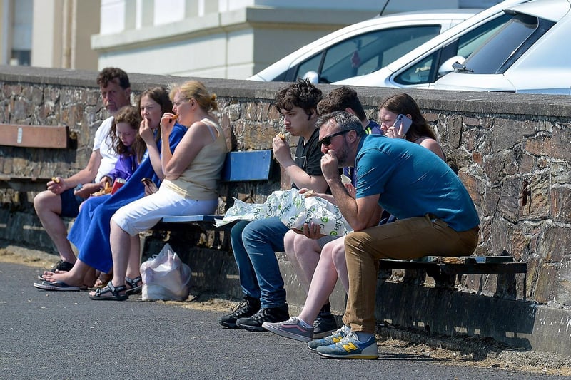 People relaxing at the shore front in Moville during the recent hot spell in Inishowen. DER2129GS - 067