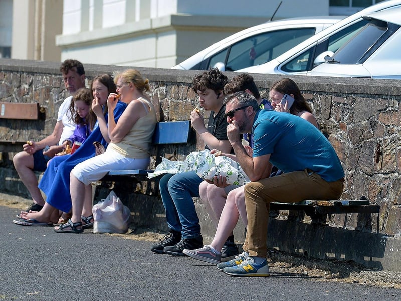 People relaxing at the shore front in Moville during the recent hot spell in Inishowen. DER2129GS - 067