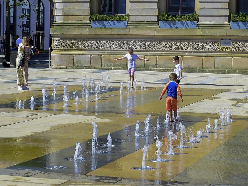 The water fountains in Guildhall Square were popular with children during the warm and sunny weather over the weekend. Photo: George Sweeney. DER2128GS – 052