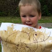 Two-year-old Jacob Duke with his cave painting
