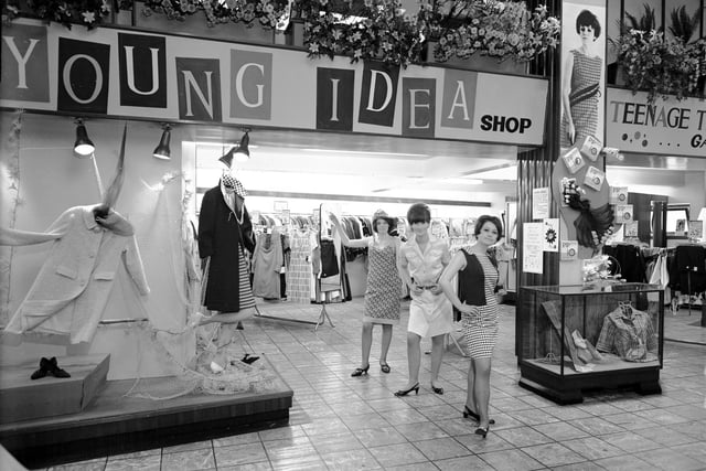 Three women model clothes in front of the Young Idea shop in the Leith Provident centre in May 1966.