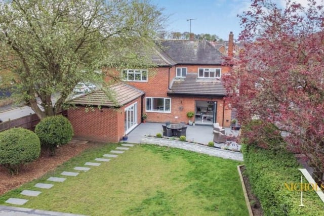 A revealing aerial view of the rear of the £550,000 property, showing the larger-than-average back garden, with its lawn, and also, to the left, the entertainment room.