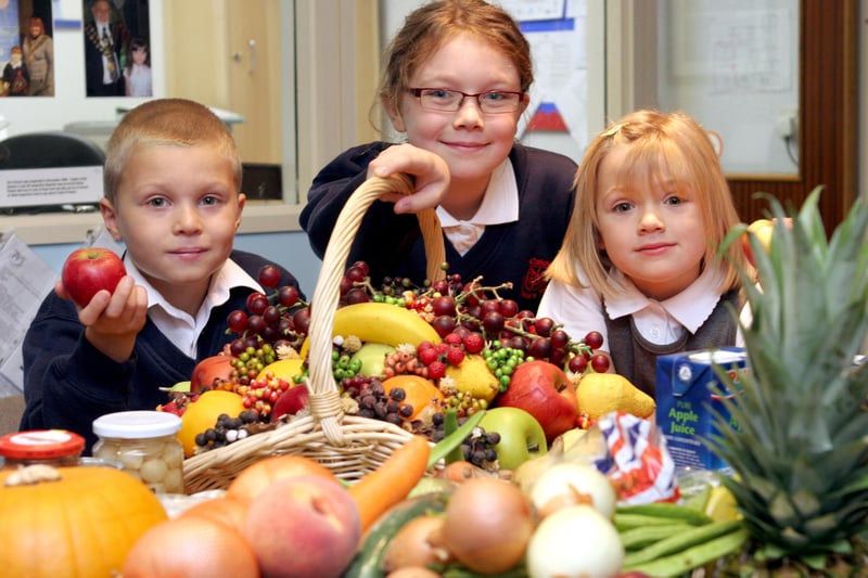 Calow Primary School pupils Oliver Emment, 7, Maisy Ainsworth, 8, Erin Leece, 6 with harvest produce in 2008.