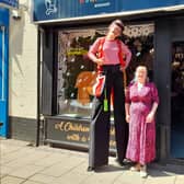 A stilt walker with Helen Tamblin-Saville at the Wonderland bookshop