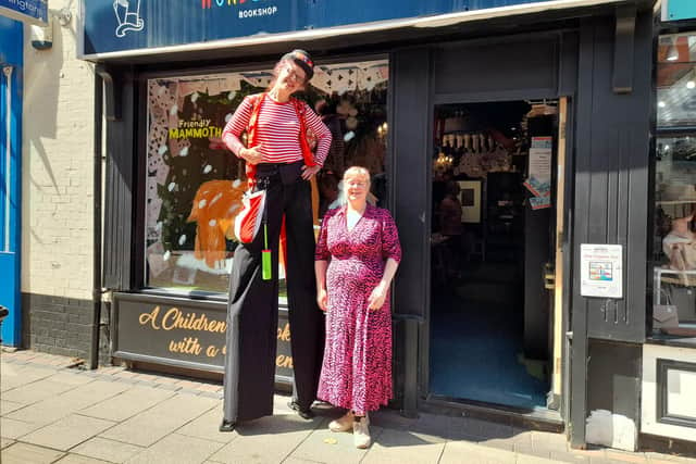 A stilt walker with Helen Tamblin-Saville at the Wonderland bookshop