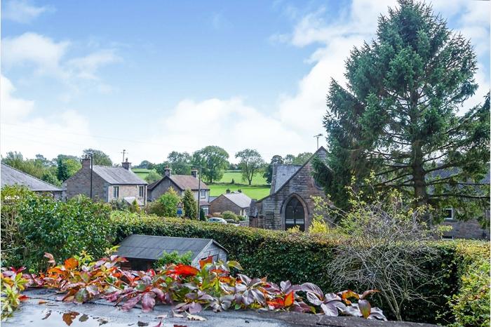 To the front of the property is a garden featuring a range of mature plants and shrubs and parking for two cars. At the rear, accessed from the kitchen or bedroom four, is a raised paved courtyard which provides lovely views of the village.