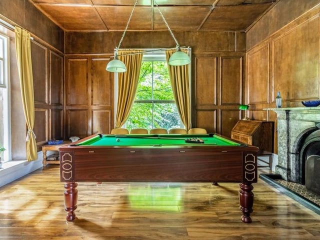 A real throwback to Victorian times is this wonderful billiards room, with its wooden wall-panelling, wood flooring, large sash windows and ornate fireplace. Perfect for after-dinner entertainment.