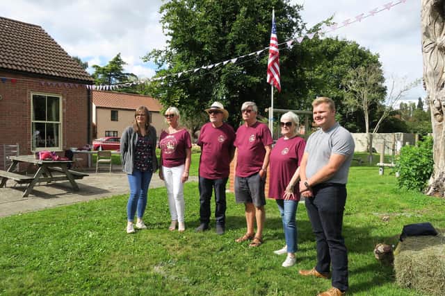 Parish councillors with county councillor Tracey Taylor and district councillor Jack Bowker - with a flag gifted by the people of Plymouth, Massachusetts, in the background