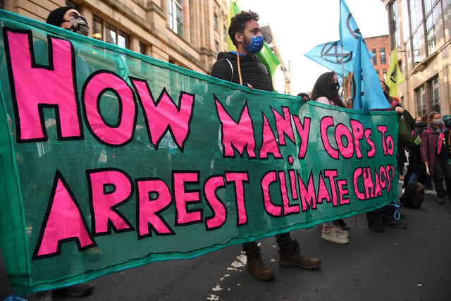 Climate activists from the Extinction Rebellion group demonstrate outside the offices of JP Morgan in Glasgow.