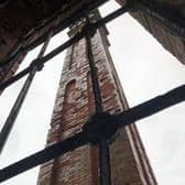 The 1880s structure’s huge chimney through a window