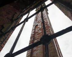 The 1880s structure’s huge chimney through a window