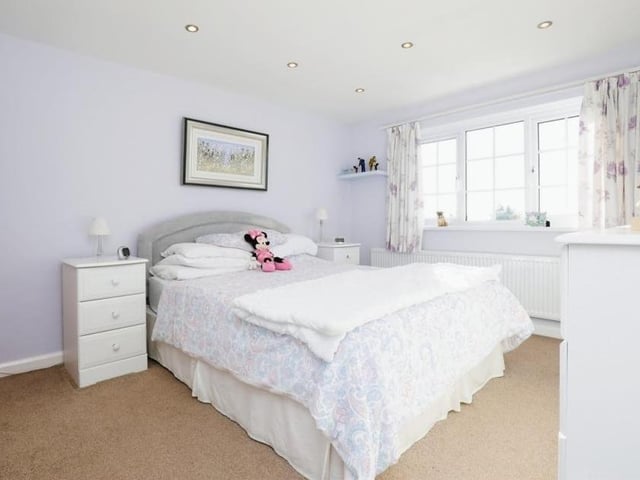 Moving upstairs, it's time to take a look at the bedrooms. The master  is a spacious double that overlooks the front of the house. It has access to an en suite bathroom, which comprises an enclosed shower cubicle, wash hand basin and WC, with spotlights and fully tiled walls and floor.
