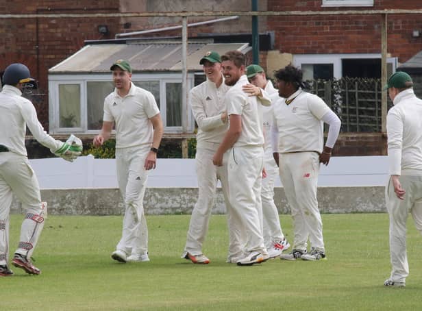 Woskop captain Harry Taylor is congratulated after taking a spectacular catch.