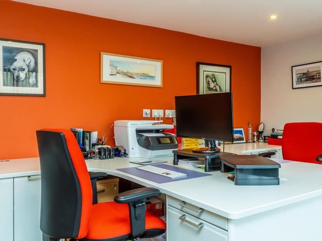 Among the rooms on the ground floor of the house is this smart and well-equipped home office.