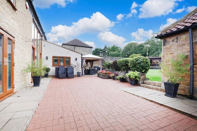 The garden at the £870,000 farmhouse has lots of outdoor space for relaxing or for entertaining family and friends.