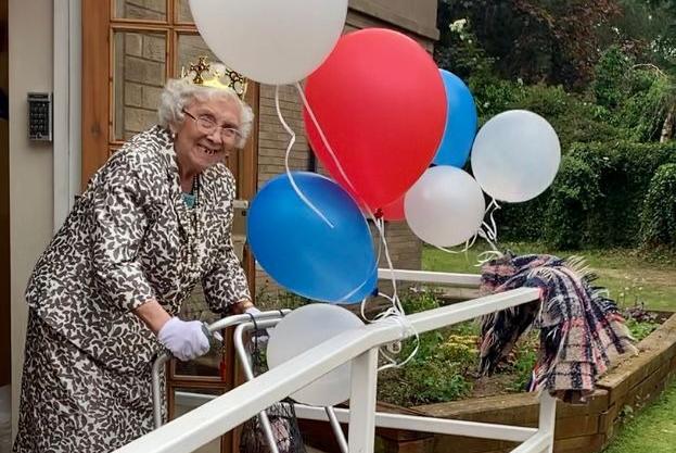 Elena McFarlane, age 96, was voted for by staff to be the care home's queen for the day. Residents waved their flags as Elena came onto the balcony.