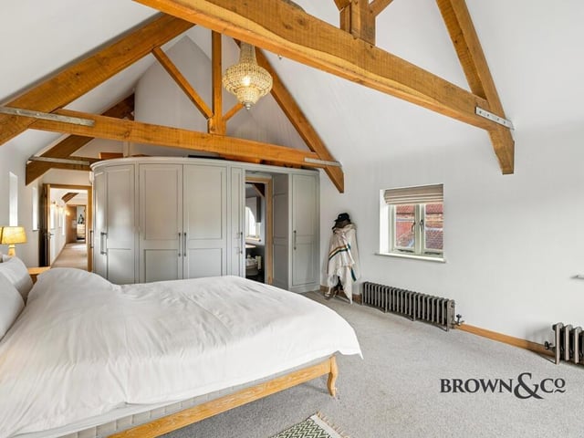 Curved furnishing and a hidden en suite feature in this luxury first floor bedroom.