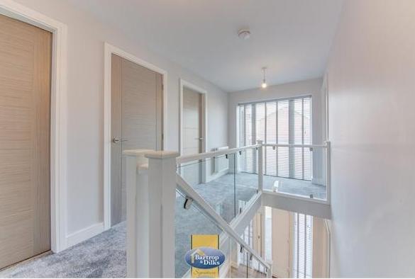 Stunning open landing with glass panelled staircase and full length front facing window, cylinder airing cupboard, spot lighting to the ceiling.