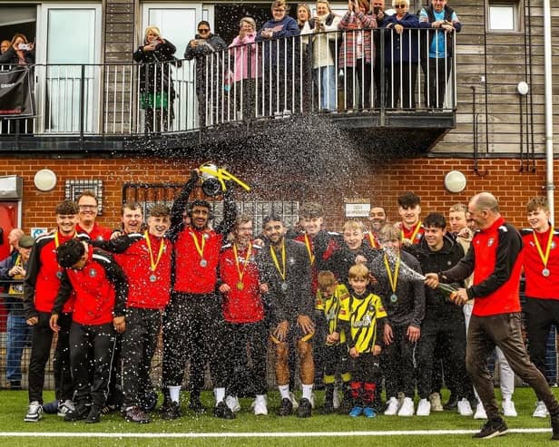 Worksop Town Reserves celebrate their Trophy triumph.