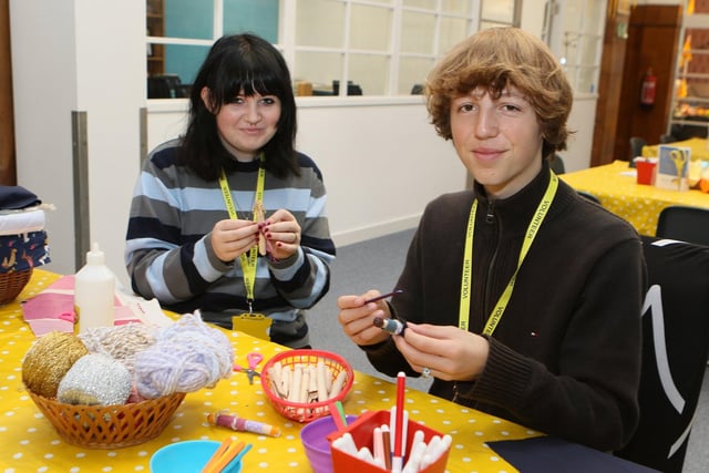 Aurora Wellbeing volunteers Seth Boys and Alyssa Humphreys making peg dolls