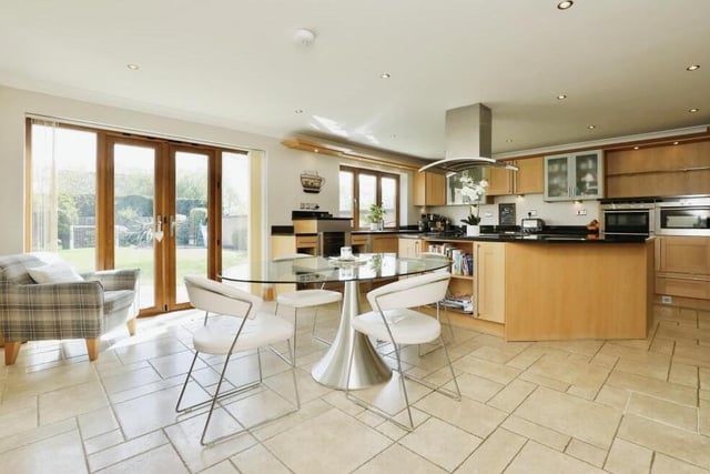 This is the dining area of the kitchen, with French doors offering views of and access to the back garden
